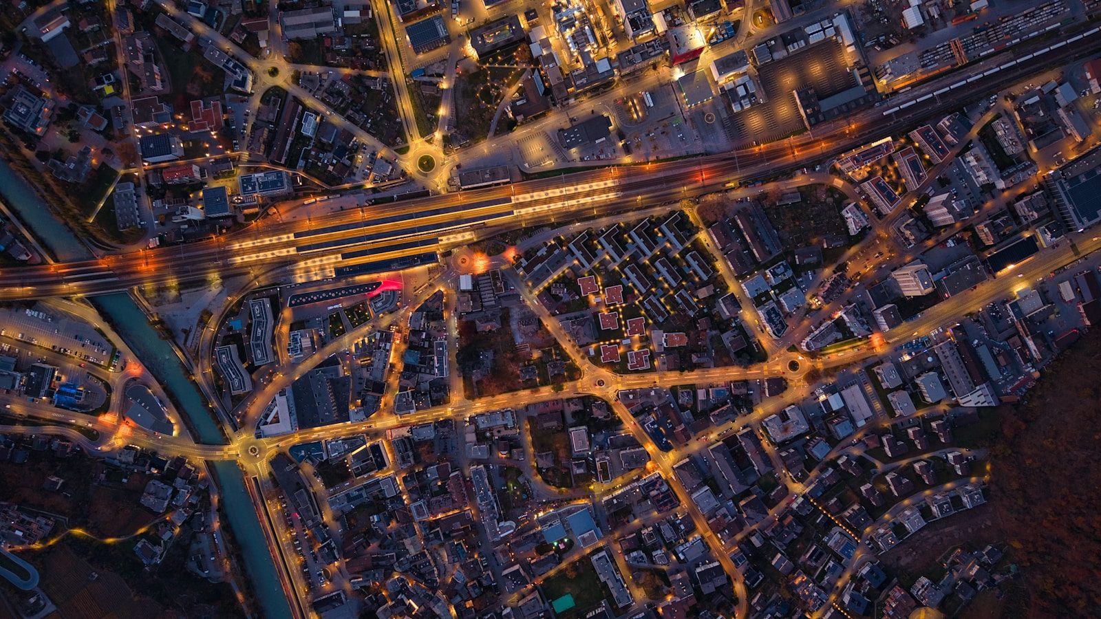 Aerial view of a city at night with illuminated streets.