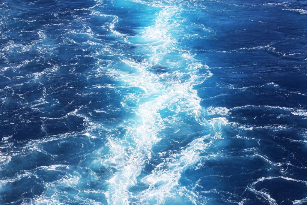Captivating view of ocean waves showcasing the vibrant deep blue sea and white foam patterns.