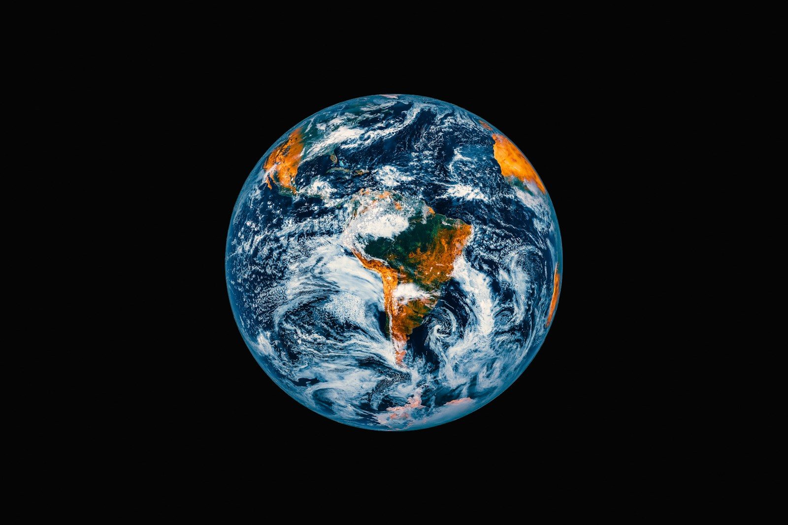 Planet earth seen from space with clouds and continents.