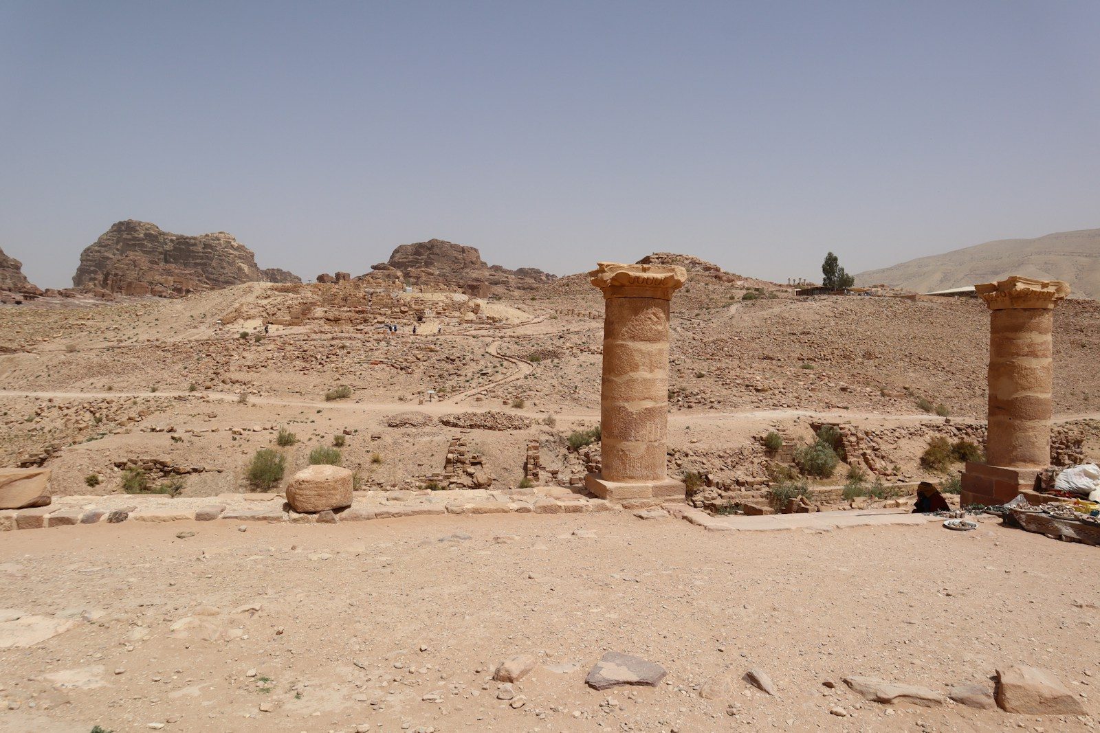 a couple of stone pillars sitting in the middle of a desert