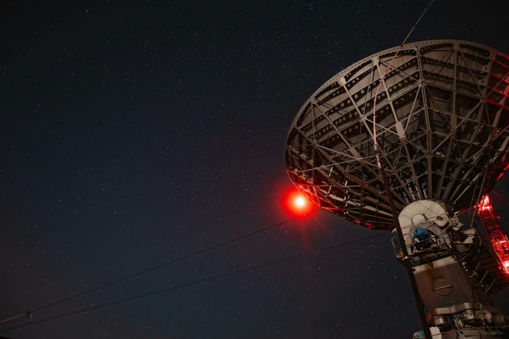 a radio tower with a red light on top of it