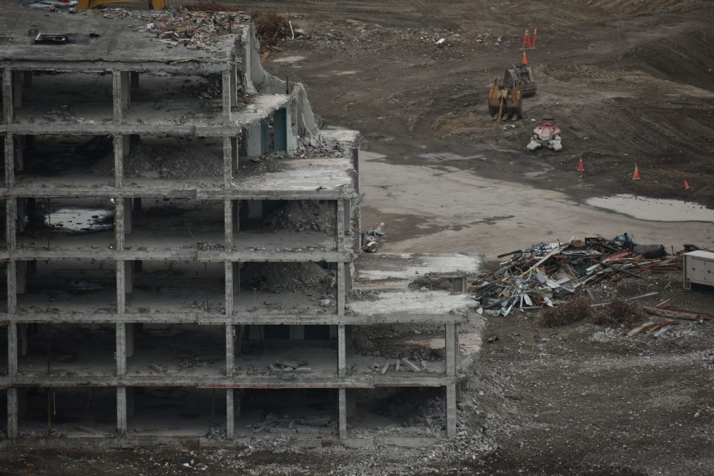 Building demolition reveals skeletal structure and debris.