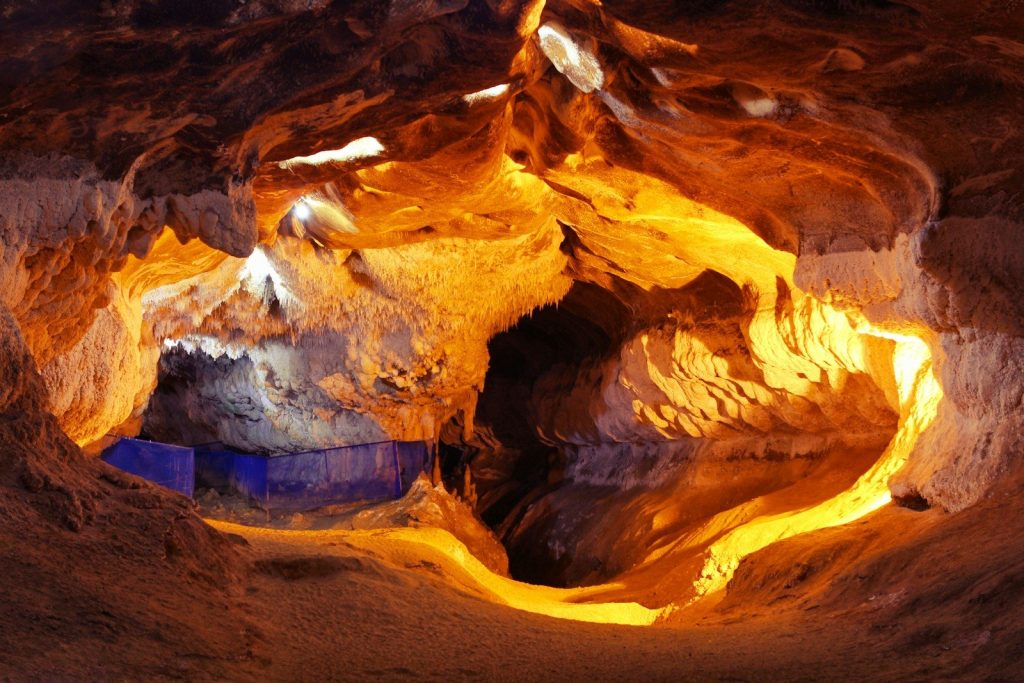 A cave filled with lots of rocks and water