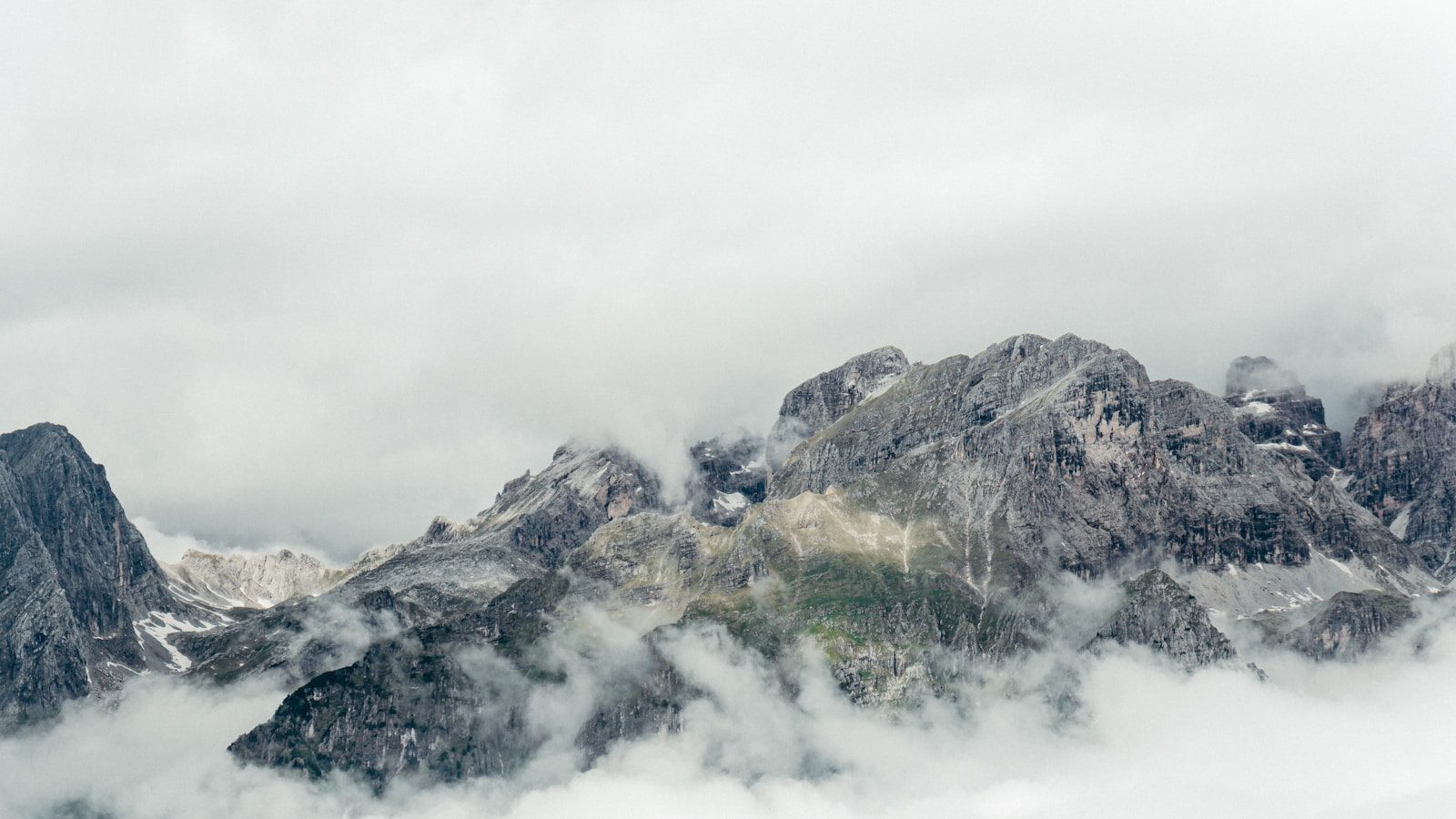 Rocky mountains shrouded in mist and clouds.