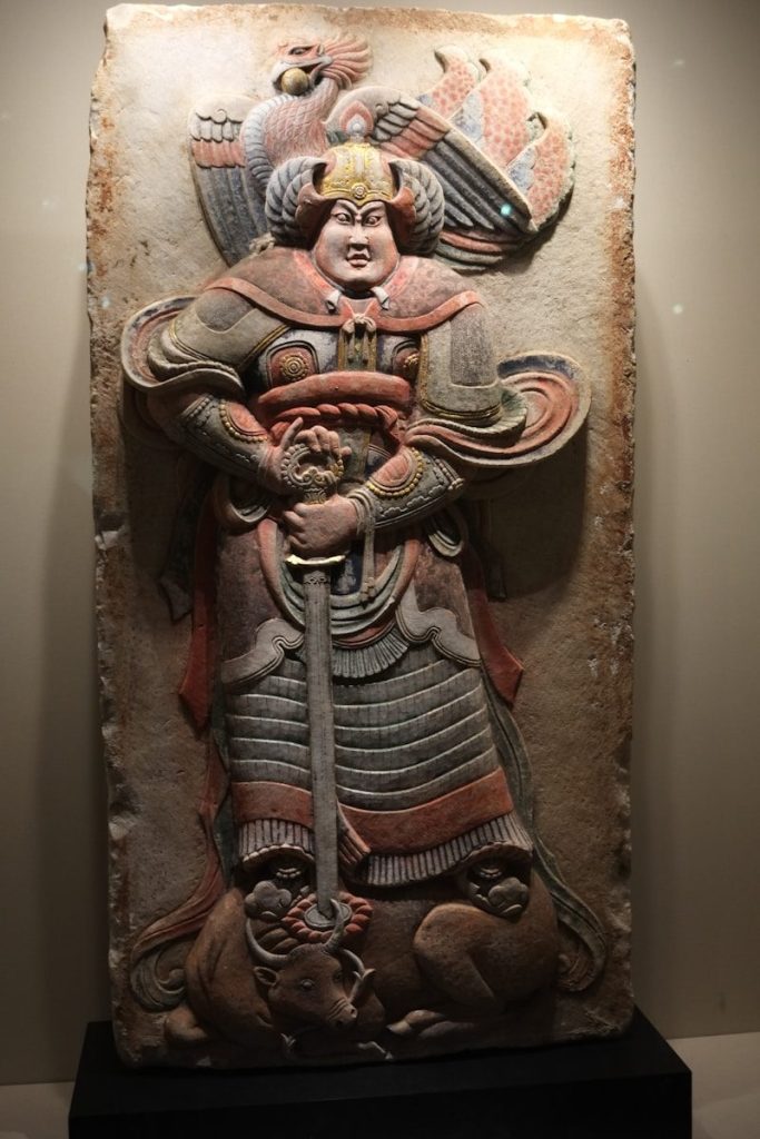 A sculpture of a woman holding a sword