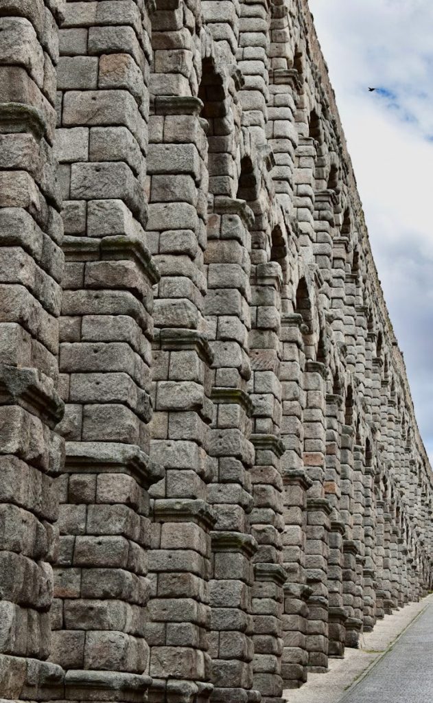 a stone wall with a stone arch