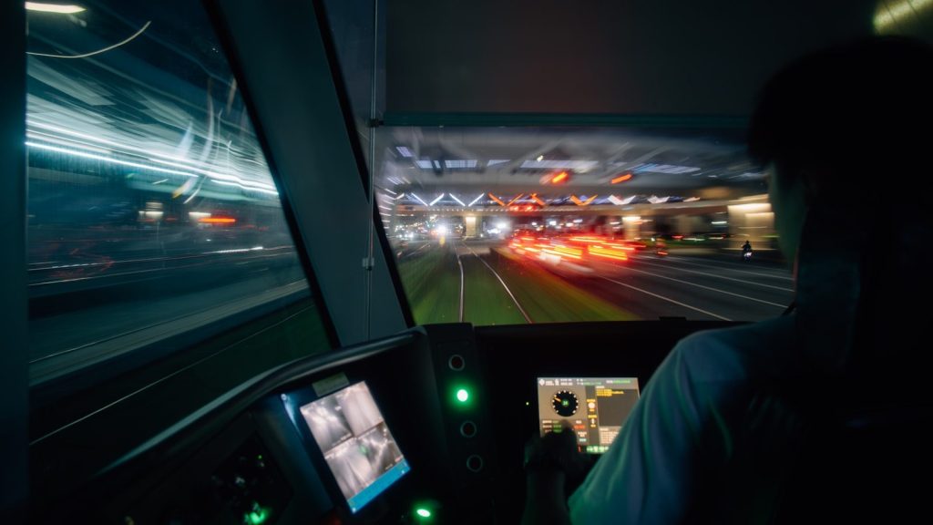A man driving a bus at night time
