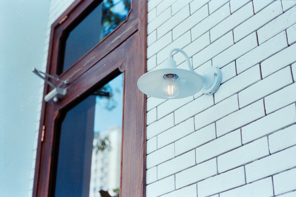 White wall light on a white brick wall