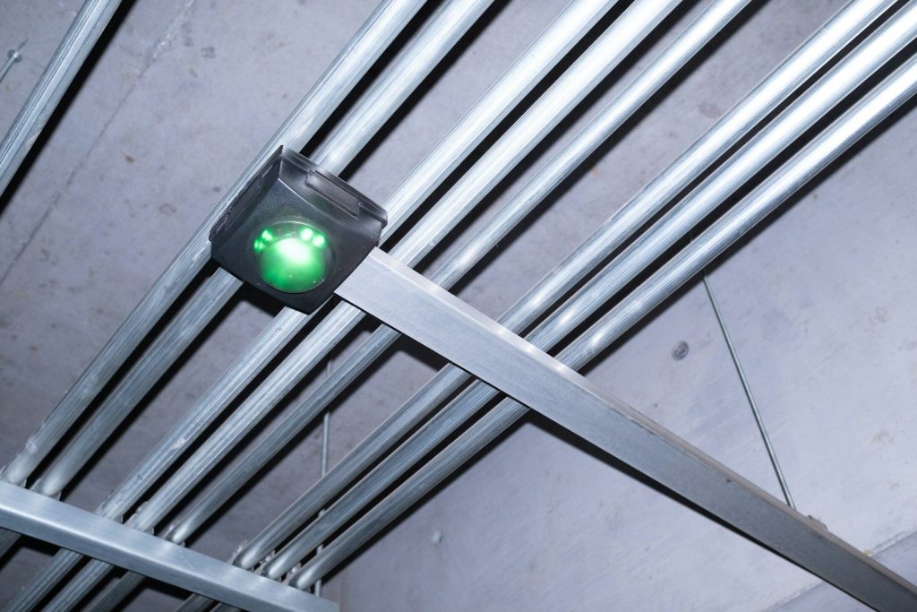 Electrical wiring and light fixtures are mounted on the ceiling.