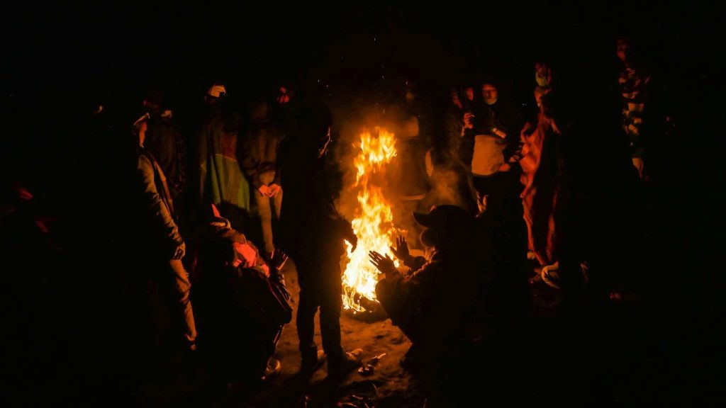 people standing near bonfire during nighttime