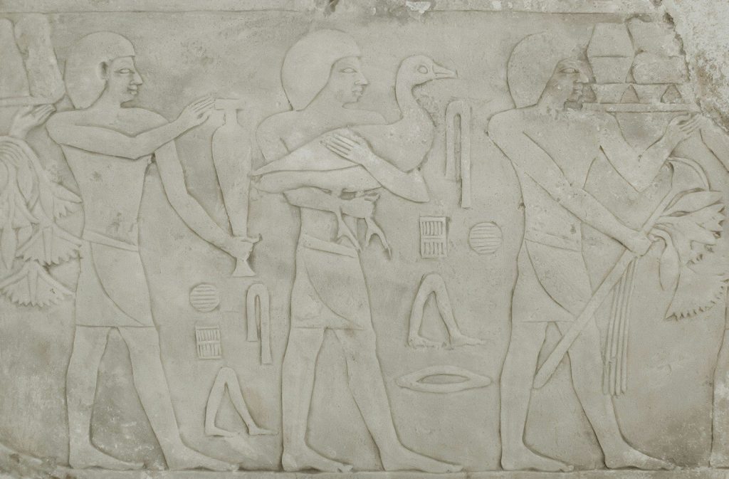 Ancient egyptian relief carving of men carrying offerings