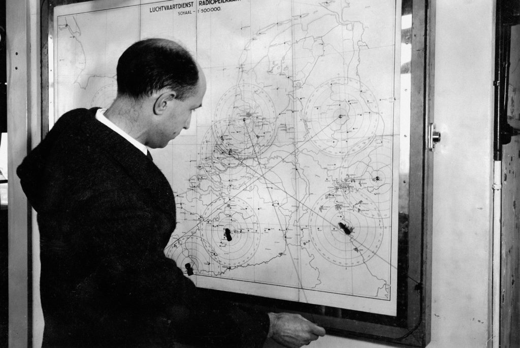 Man studying a large map with circular patterns.