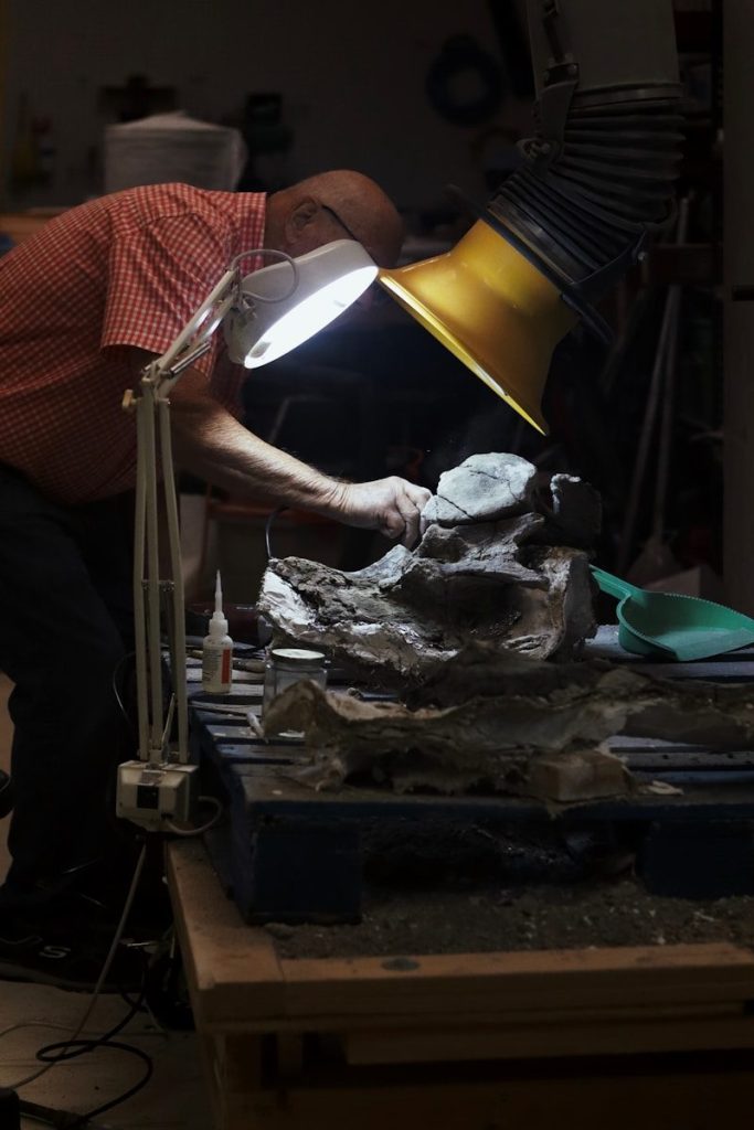A man working on a lamp in a room