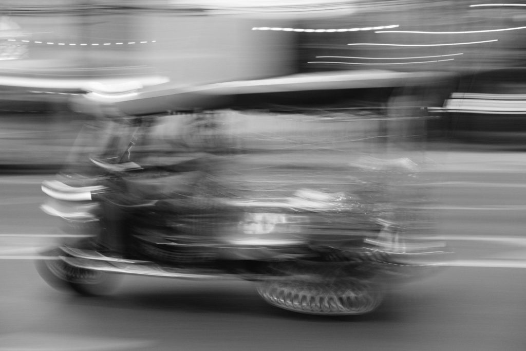 a black and white photo of a person on a motorcycle