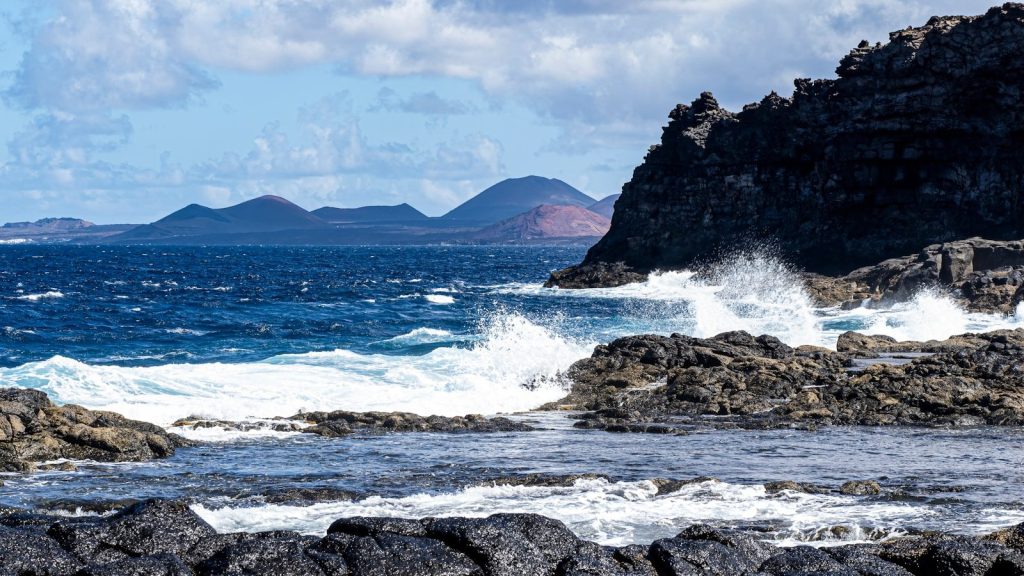 a large body of water near a rocky shore