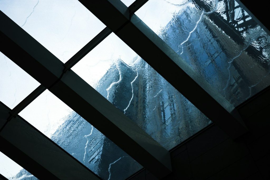 a view of a snowy mountain through a window