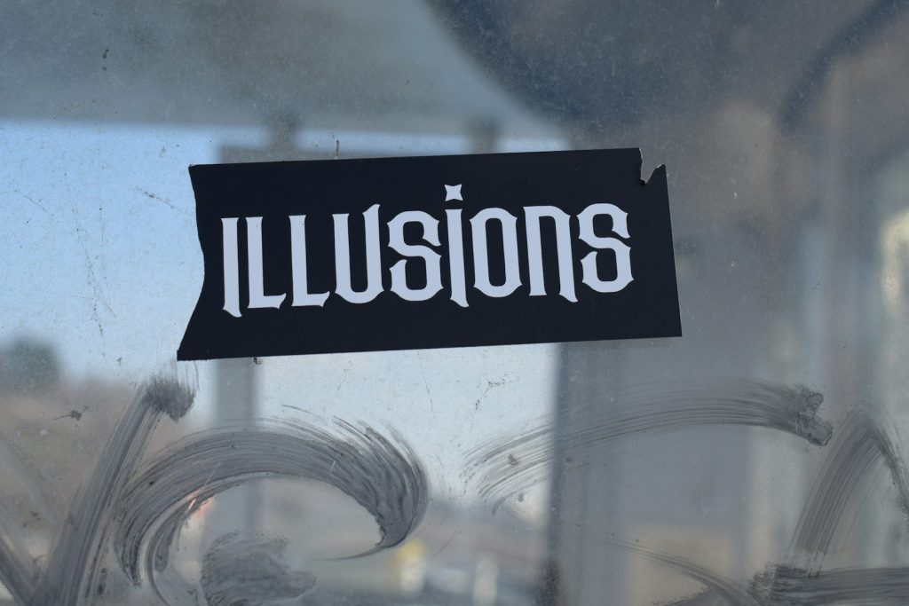 a sticker on a glass door that says illusion