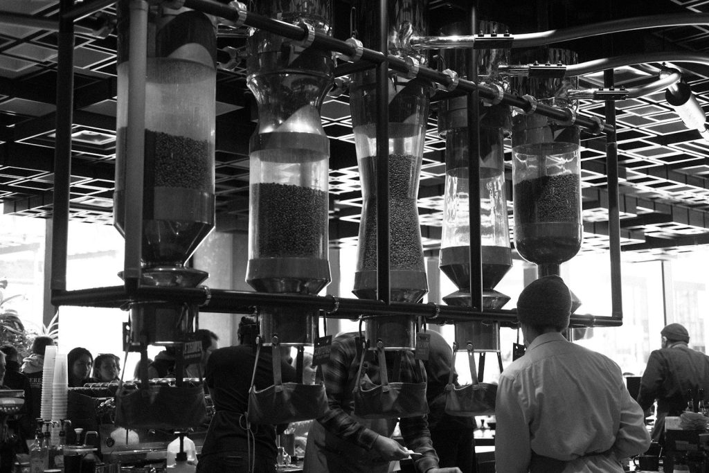 A black and white photo of people working in a factory