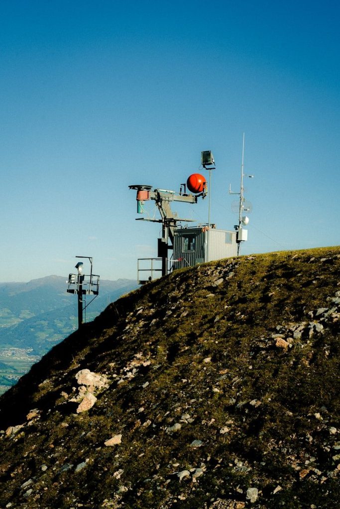 Weather station on a grassy mountain peak