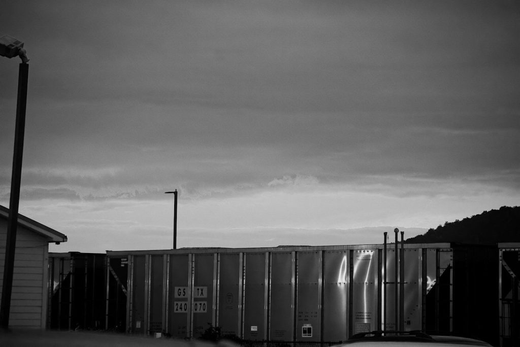 Industrial storage containers under a cloudy sky