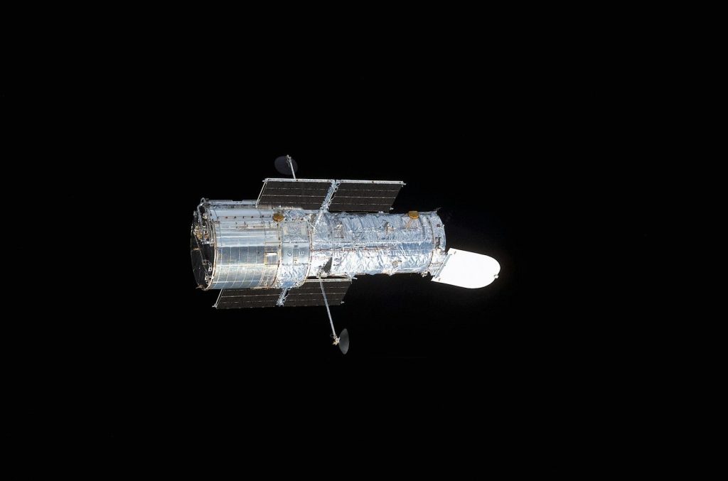 a satellite in the dark with a black background