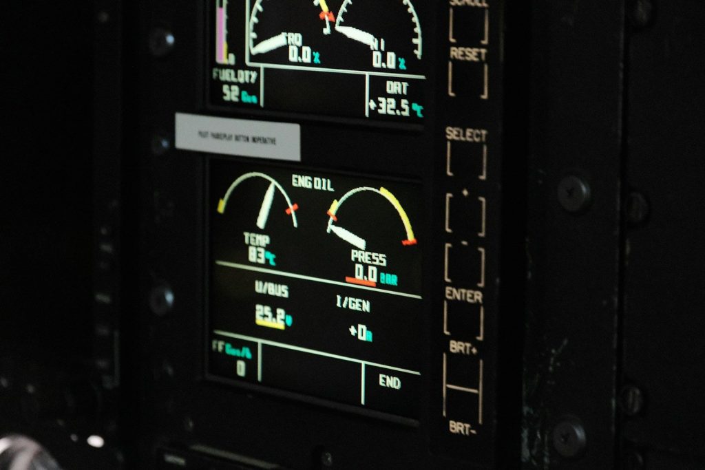 Digital gauges and readings on an illuminated cockpit display.