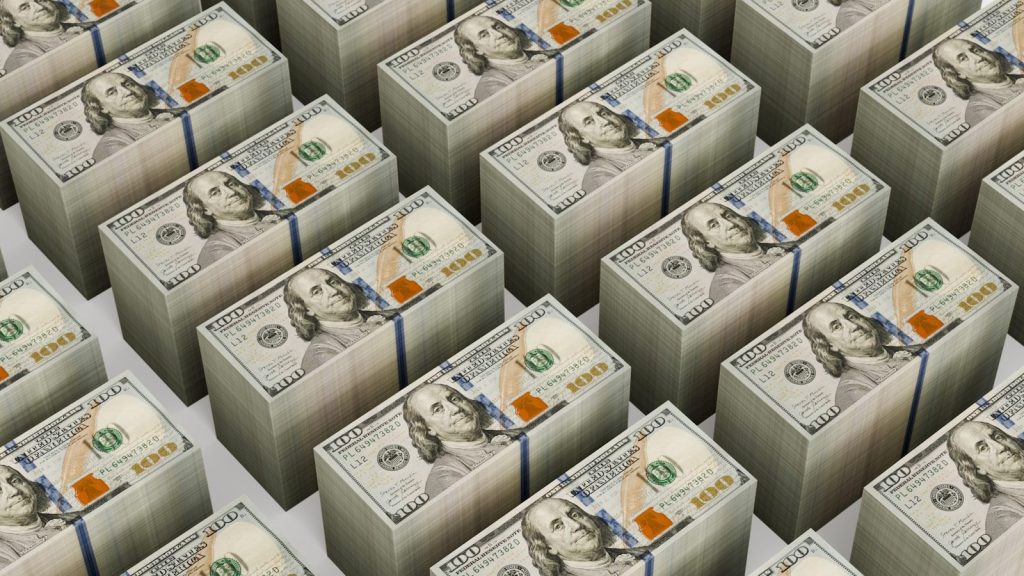 Stacks of $100 bills are neatly arranged.