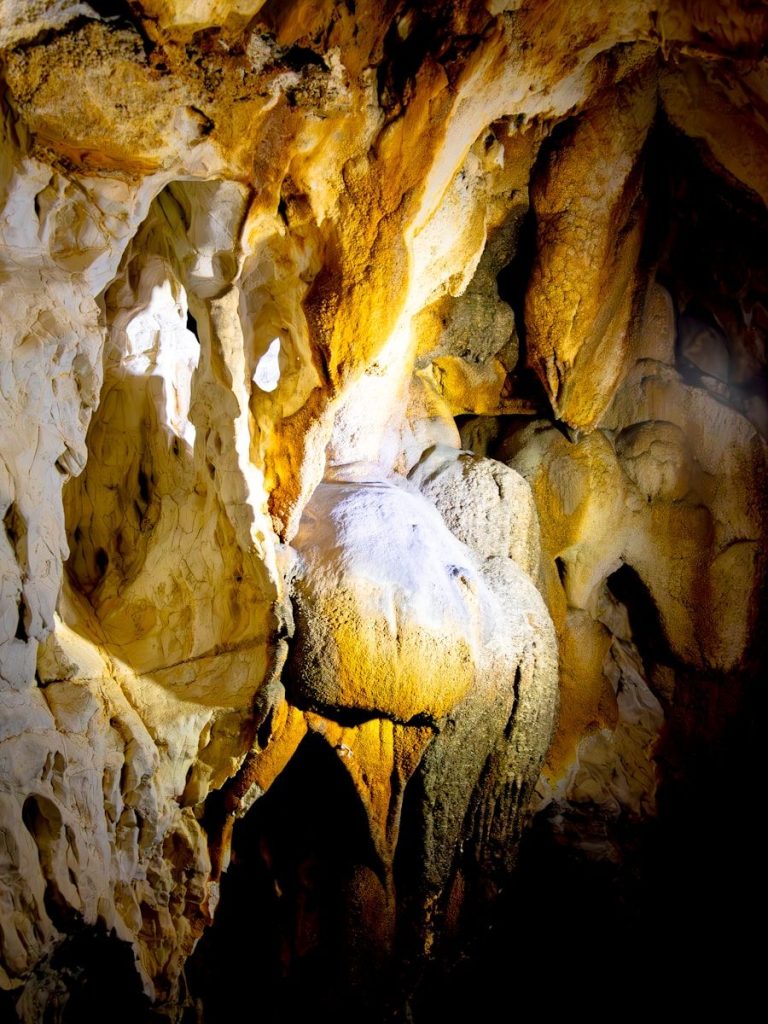 Interior of a cave with stalactites and stalagmites.