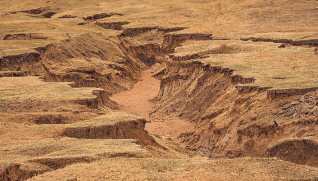 Erosion has carved a deep ravine in the landscape.