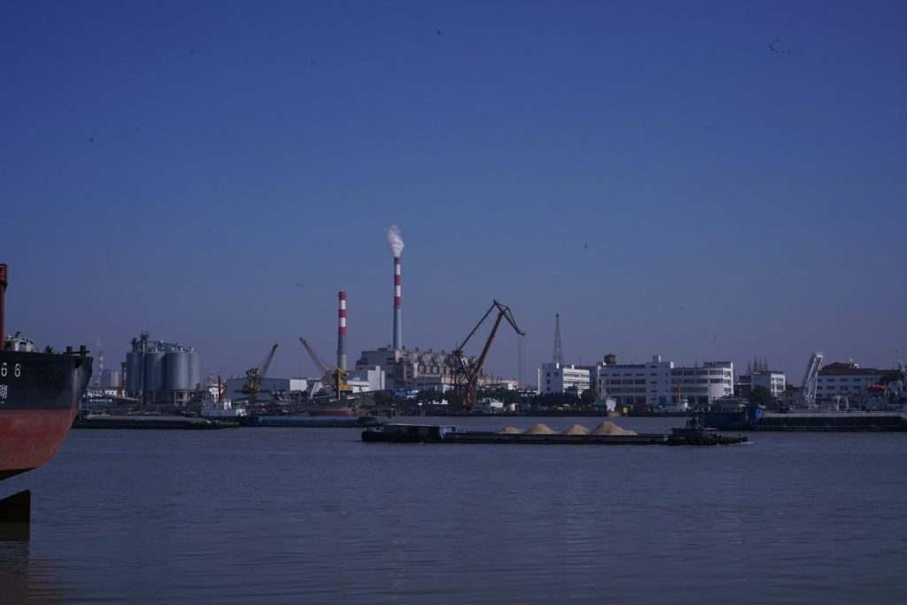 a large body of water with a boat in the foreground