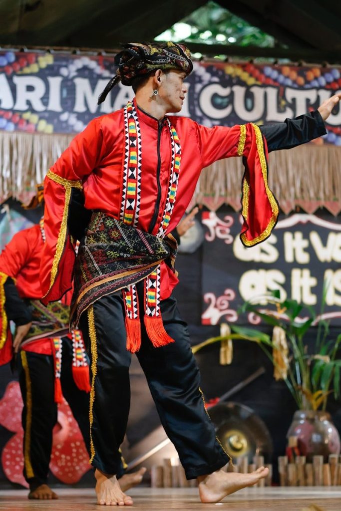 Man in traditional red and black costume dancing