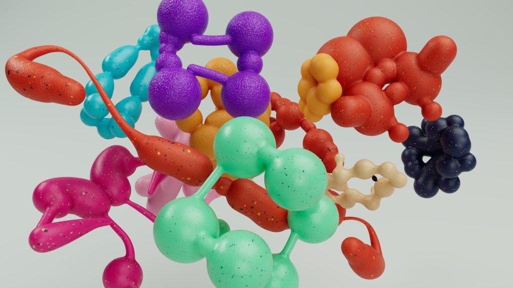 A vase filled with lots of different colored balloons