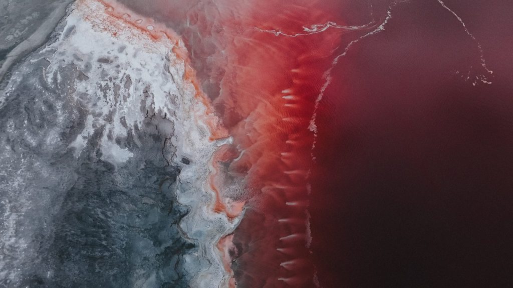 A red and white photo of a large body of water