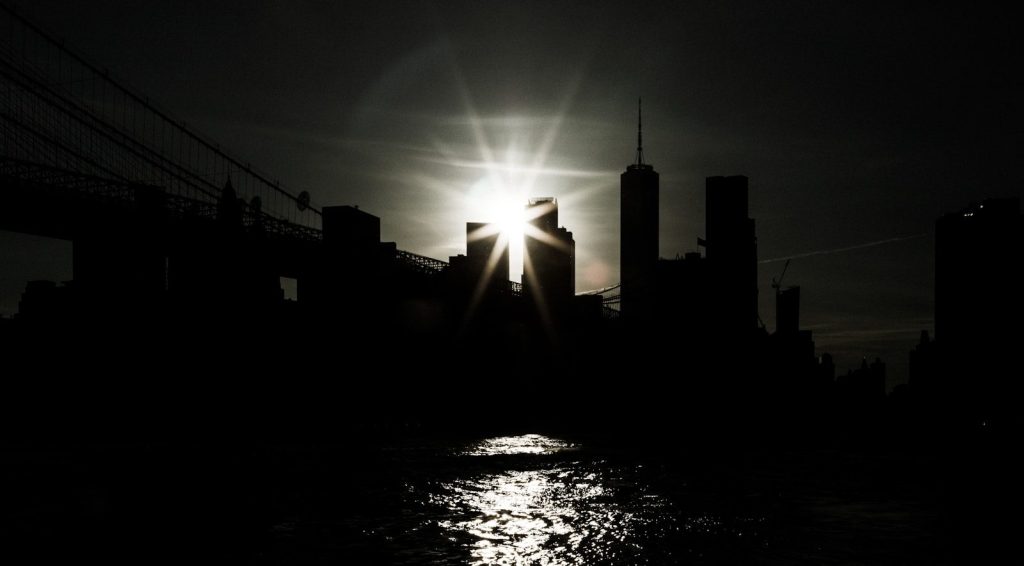 the sun is shining brightly over a city