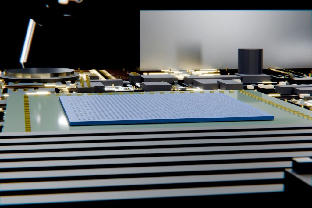 A rectangular microchip on a dark circuit board.