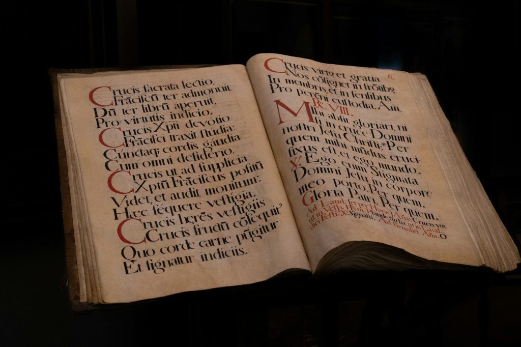 an open book with writing on it in a dark room