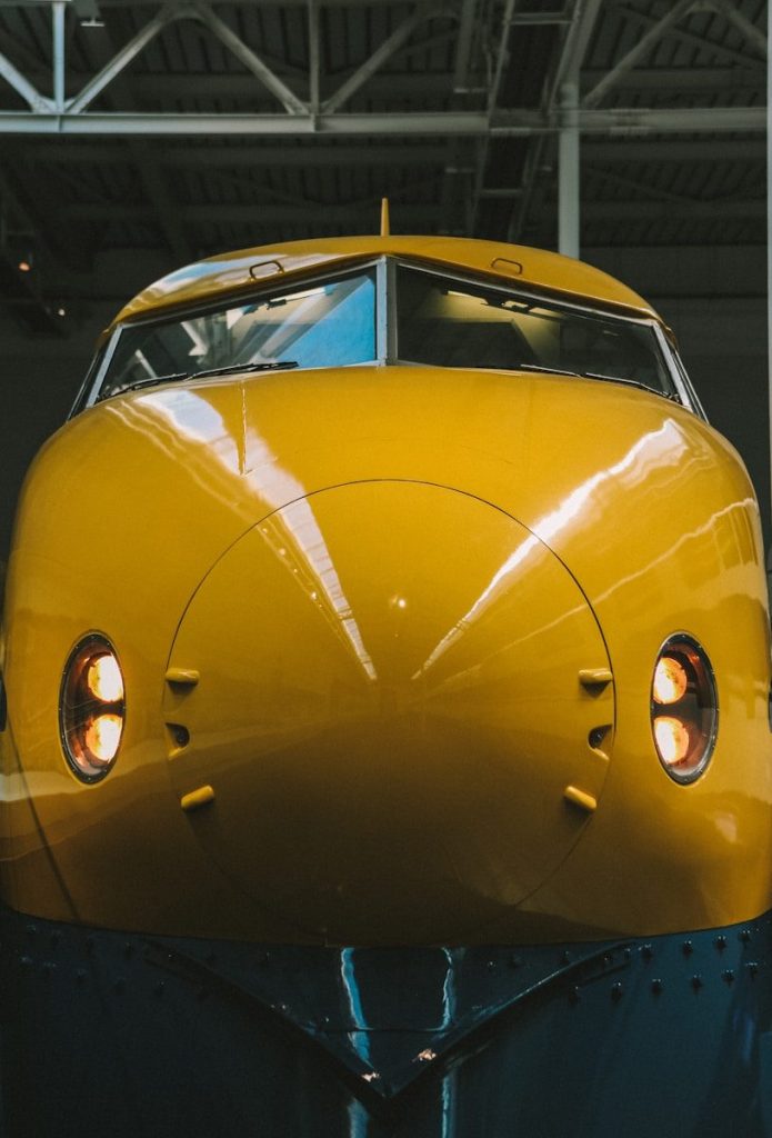 A yellow train sitting inside of a train station
