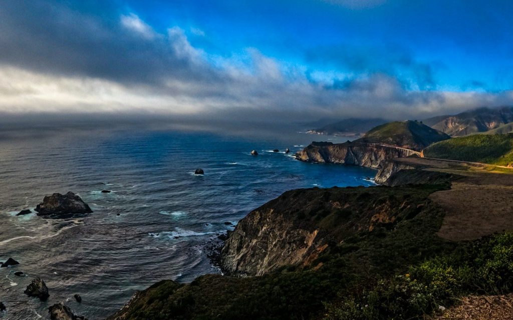 A scenic view of the ocean and mountains