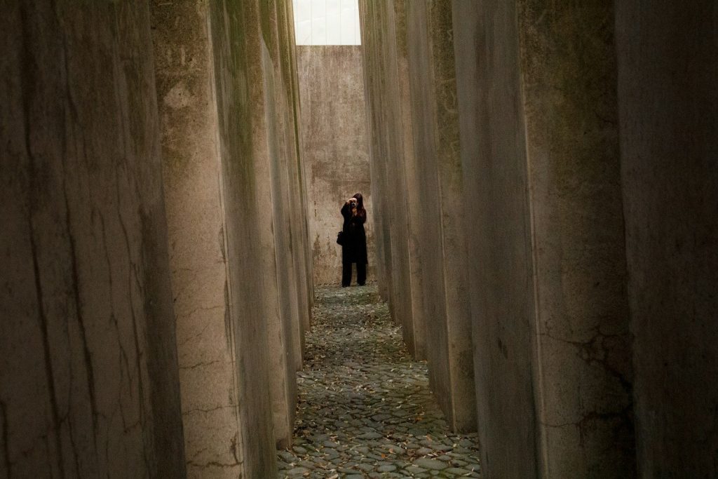 A solitary figure explores a maze of concrete slabs.