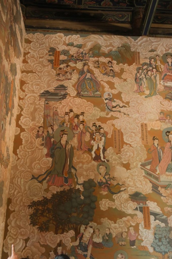 Ancient mural depicting figures among clouds and temples.