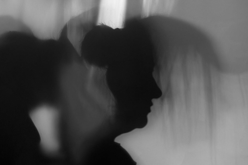 Silhouetted profile of a person in motion