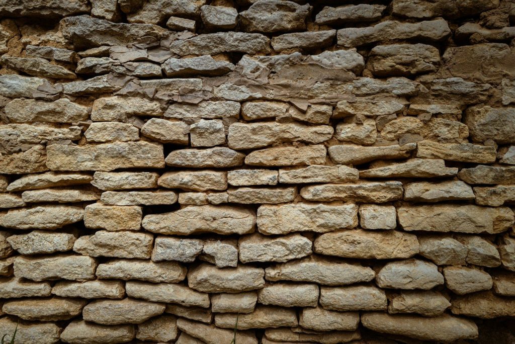 a stone wall made of rocks and cement