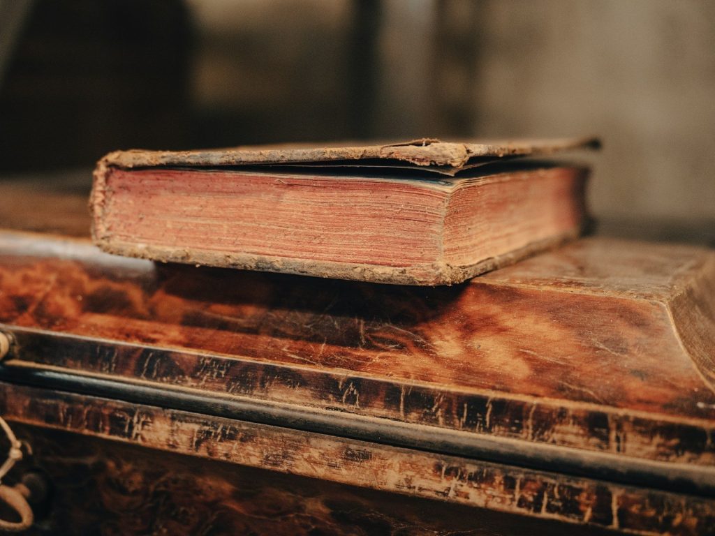 an old book sitting on top of a wooden table