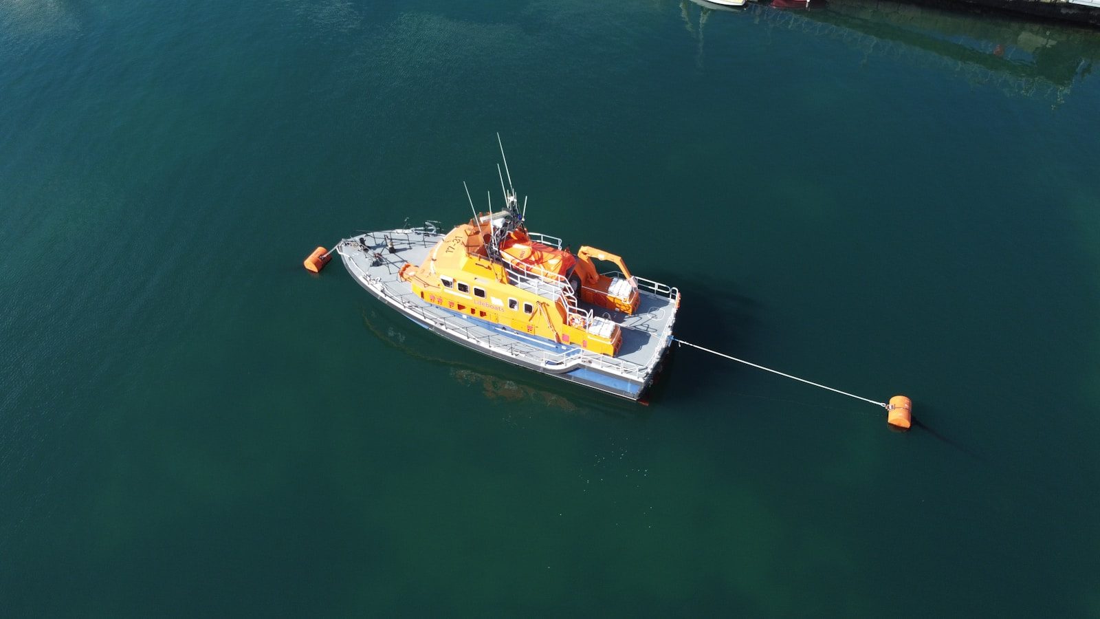 a yellow and white boat in a body of water