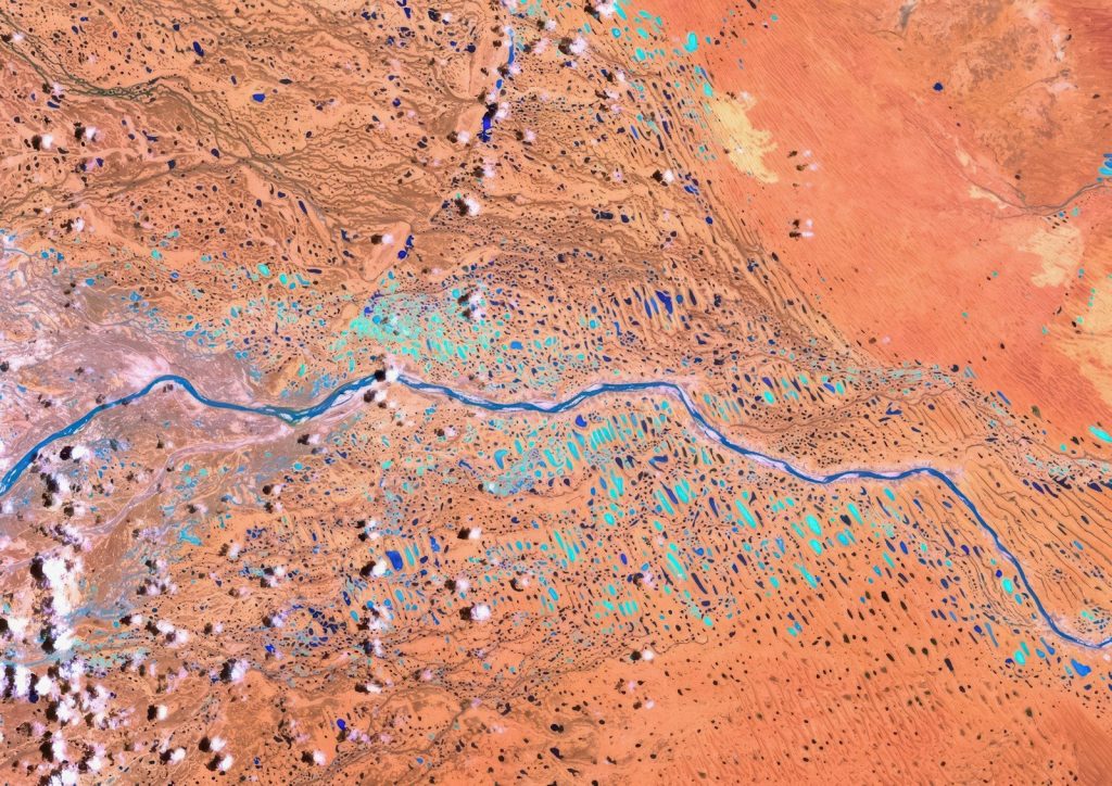 Satellite view of a winding river through arid landscape.