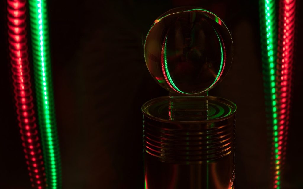 A bubble floats above a can with lights.