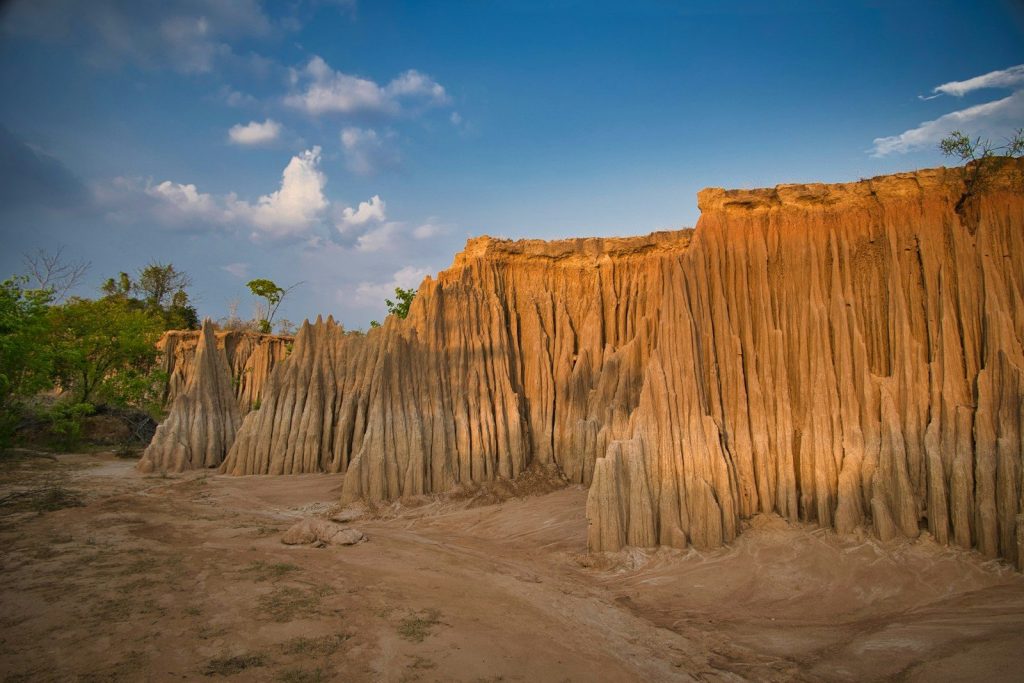 Striking eroded earth formations under a clear blue sky.