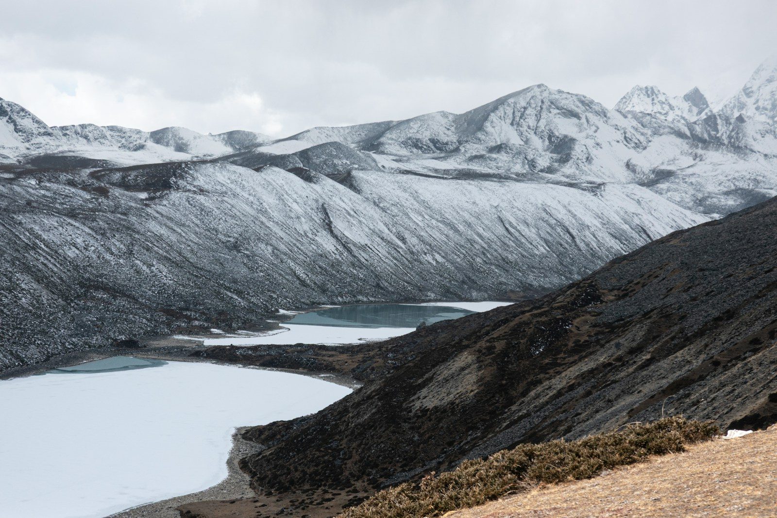 Snow-covered mountains overlook a frozen lake