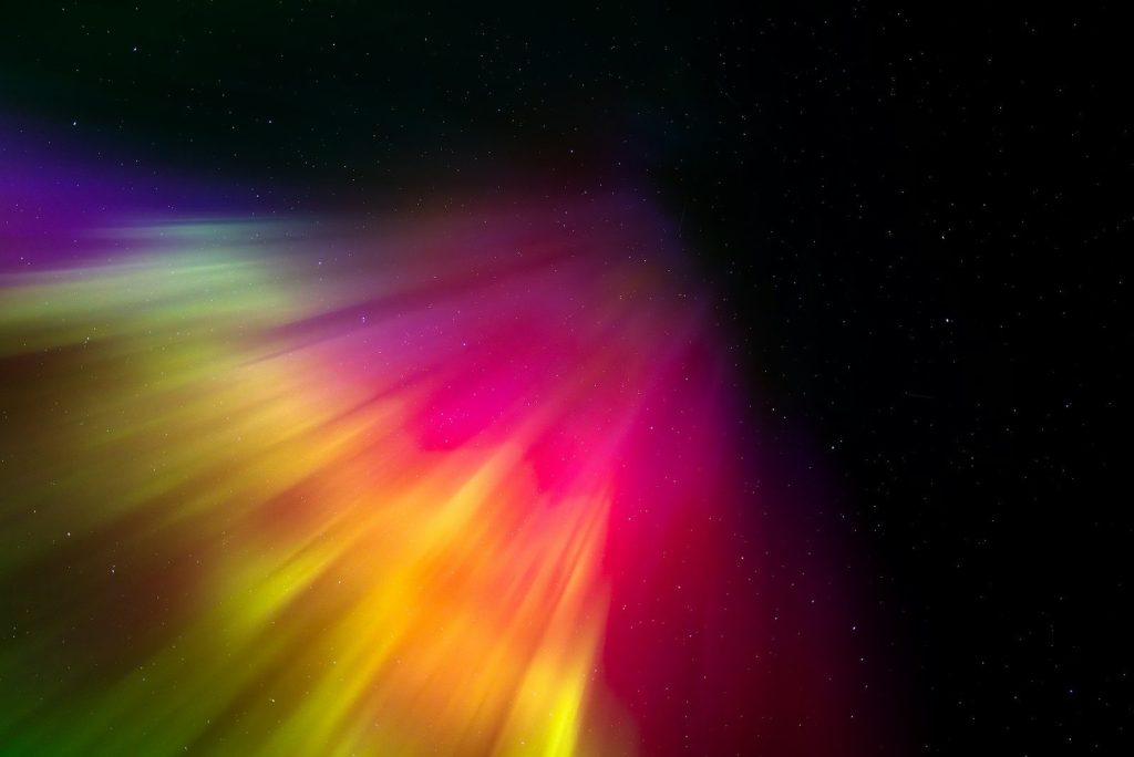 a brightly colored object is shown in the dark