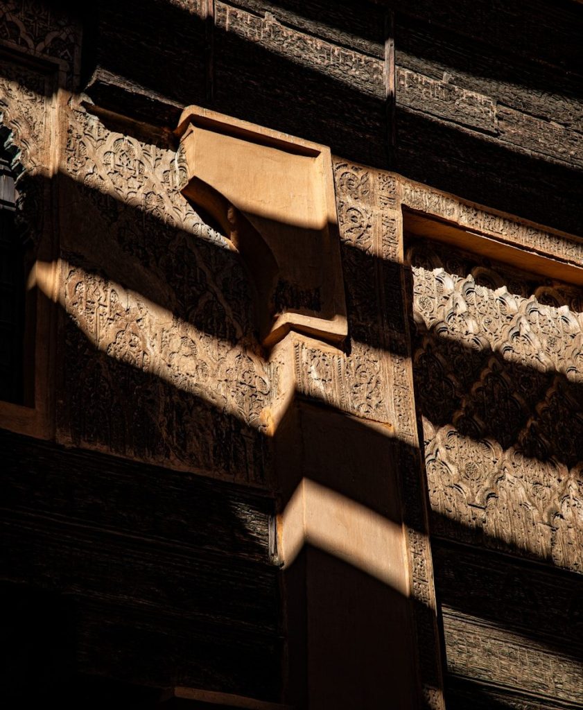 Detailed architectural carvings with dramatic light and shadow